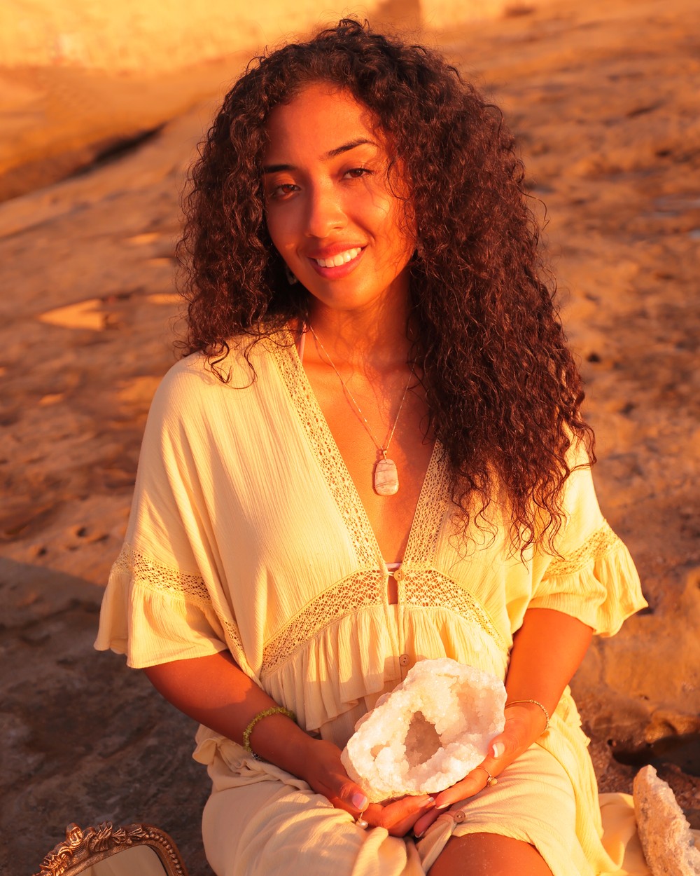 Daniella Lopez Marchinares holding a crystal geode at sunset